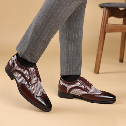 High-quality men's dress shoes, wingtip style with intricate brogue patterns for a sharp look.