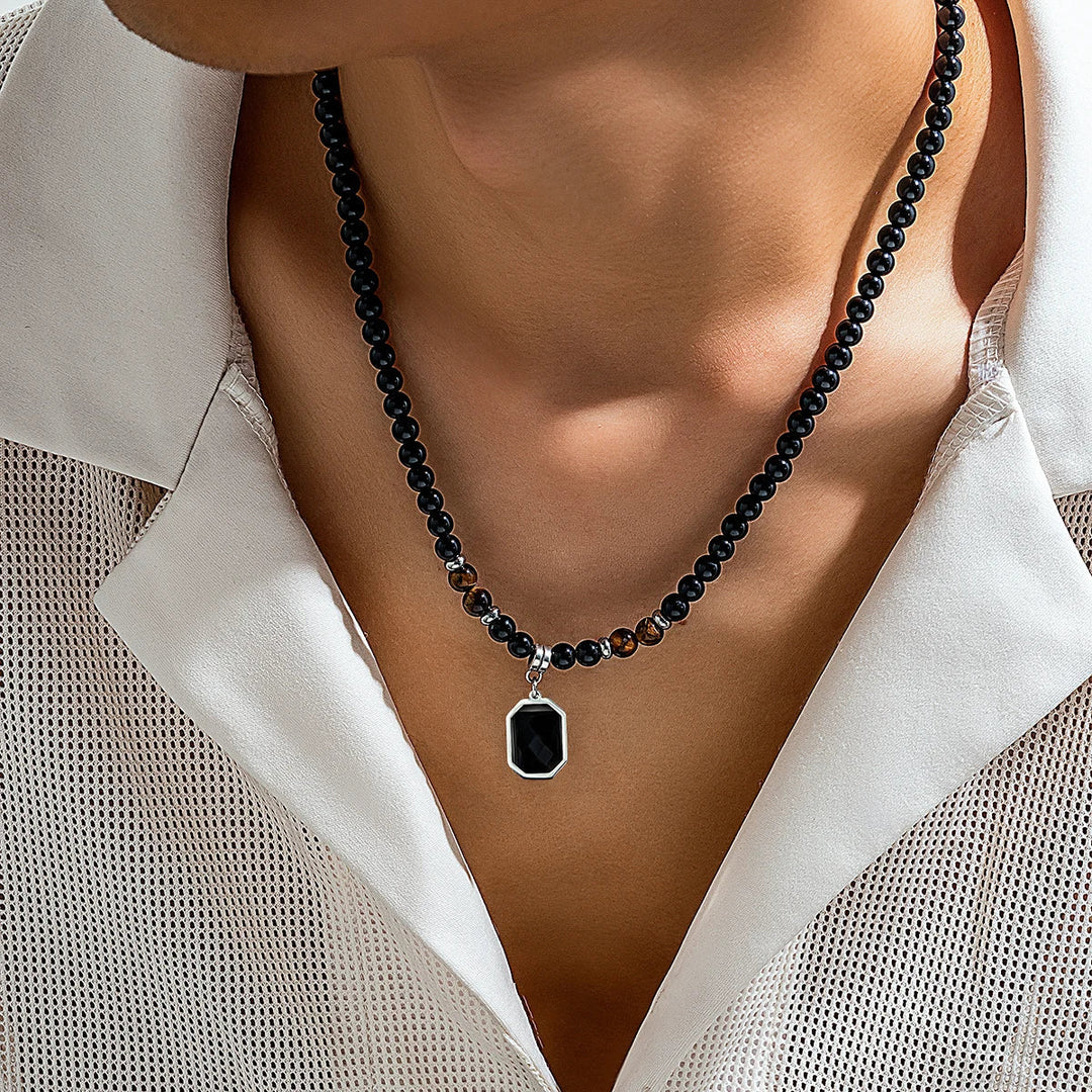 Men's black onyx beaded necklace with striking tiger's eye accents, a stylish stone jewelry accessory.