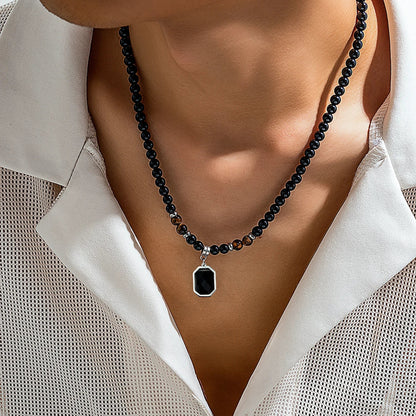 Men's black onyx beaded necklace with striking tiger's eye accents, a stylish stone jewelry accessory.