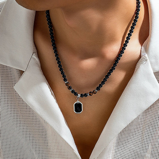 Men's black onyx beaded necklace with striking tiger's eye accents, a stylish stone jewelry accessory.
