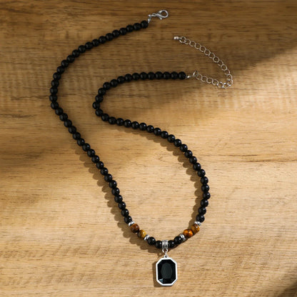 Adjustable men's black onyx beaded necklace featuring an octagon pendant & tiger's eye. Statement stone jewelry.