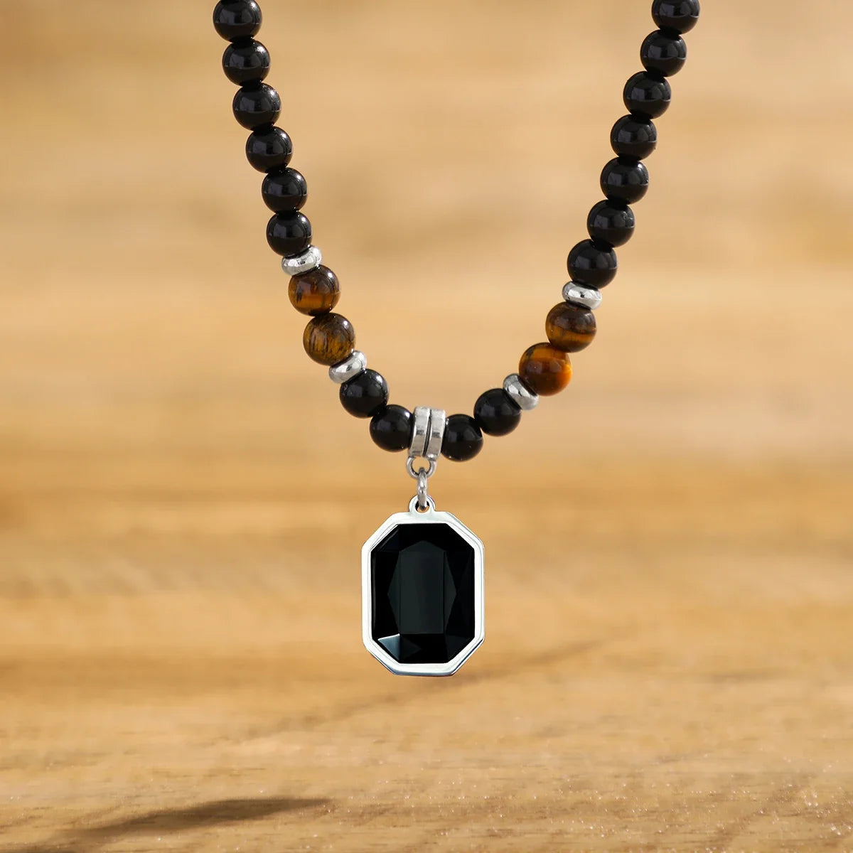 Close-up of a men's black onyx and tiger's eye beaded necklace. Elegant stone jewelry, a perfect mens accessory.