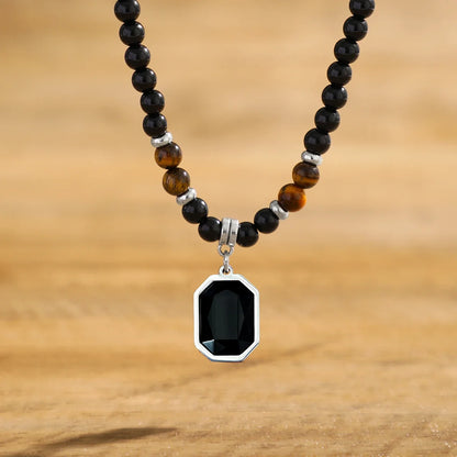 Close-up of a men's black onyx and tiger's eye beaded necklace. Elegant stone jewelry, a perfect mens accessory.