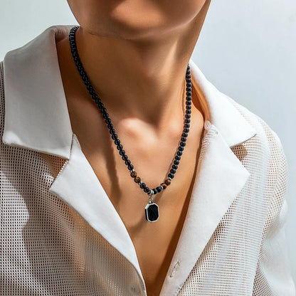 Bold mens black onyx & tiger's eye beaded necklace. A unique statement stone jewelry accessory for men.