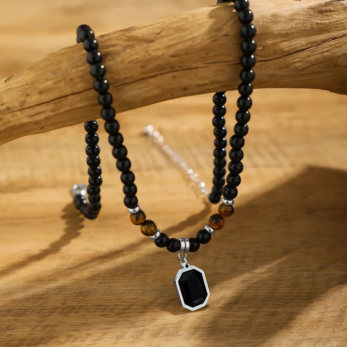Handcrafted mens black onyx beaded necklace, accented with vibrant tiger's eye stones. Modern stone jewelry.