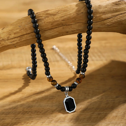Handcrafted mens black onyx beaded necklace, accented with vibrant tiger's eye stones. Modern stone jewelry.