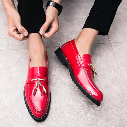Men's shiny black patent loafers with tassels, perfect slip-on dress shoes for a bold and elegant formal look.