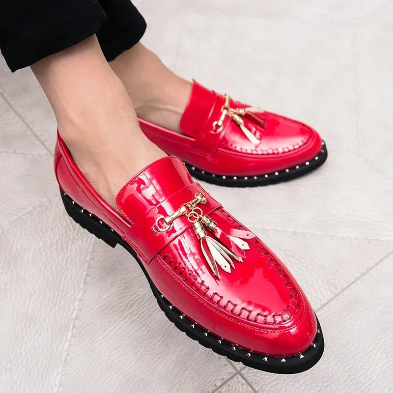 Detail of men's black patent loafers showing elegant tassels, sleek silhouette, and slip-on design for formal comfort.