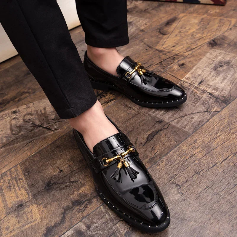 Elegant men's patent loafers with prominent tassels and subtle gold hardware. Modern formal slip-on shoes.