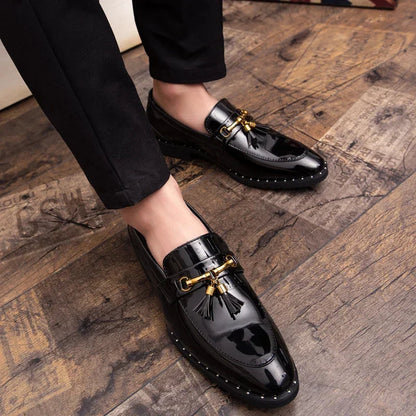 Elegant men's patent loafers with prominent tassels and subtle gold hardware. Modern formal slip-on shoes.