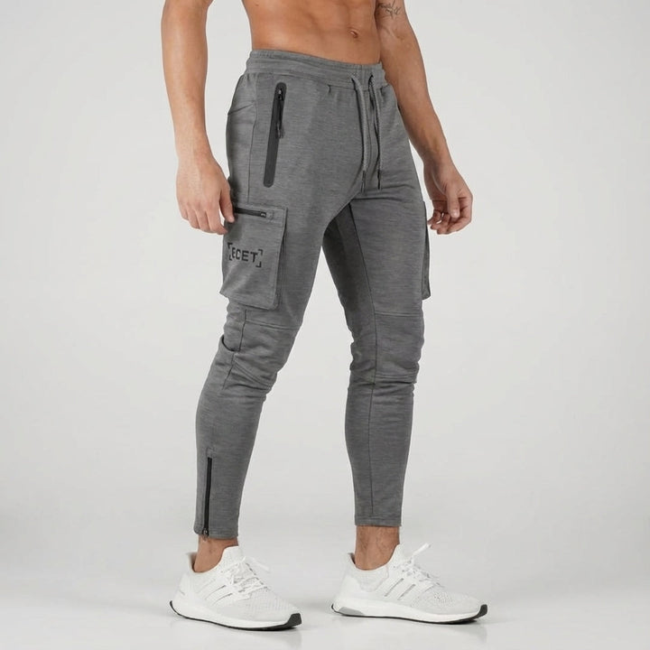 Men's athletic jogging trousers with zip pockets. Tapered fit activewear, perfect for gym and daily wear.