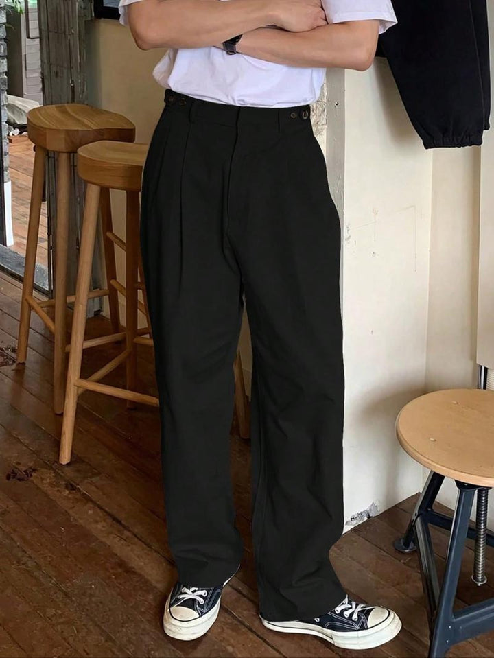 High-rise men's black pleated wide-leg trousers. Tailored modern fit for stylish, comfortable dress pants.