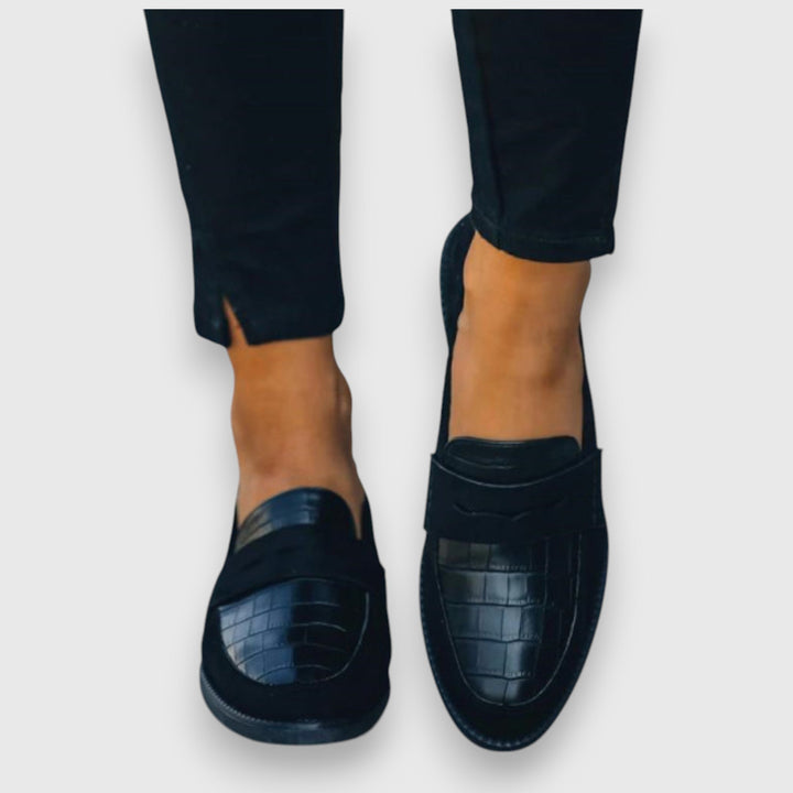 Versatile men's black slip-on loafers, stylish for business casual or dressy occasions, offering easy wear.