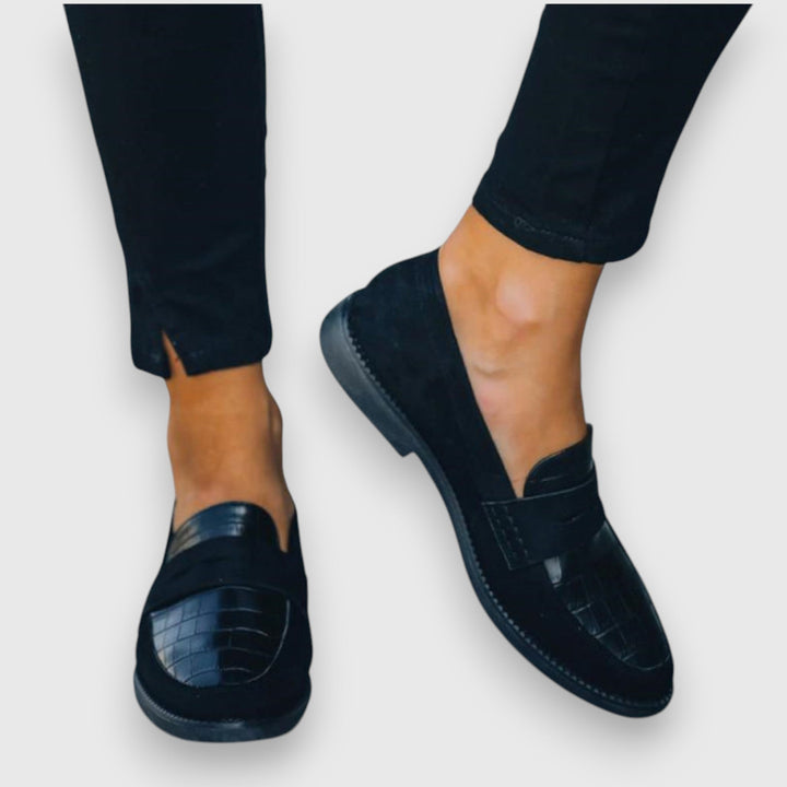 Modern men's black slip-on loafers for easy wear. Ergonomic design provides all-day comfort for any event.