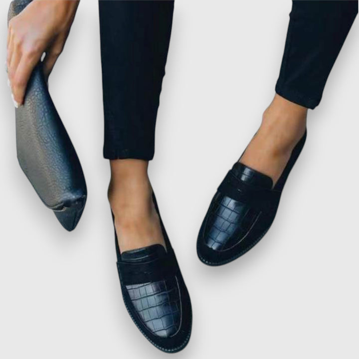 Classic men's black slip-on loafers, designed for ergonomic comfort. Ideal dress or casual footwear for men.
