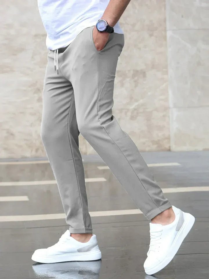 Green men's versatile drawstring chino pants, stretch fabric for modern comfort & casual look.