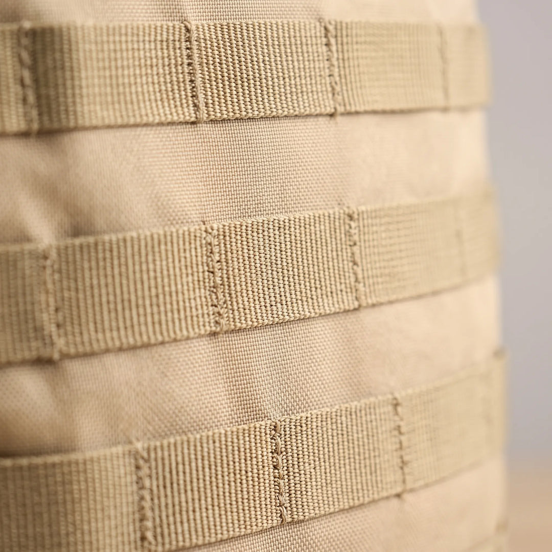 Side view of a men's durable tactical backpack, perfect for outdoor adventures with side pockets & compression straps.