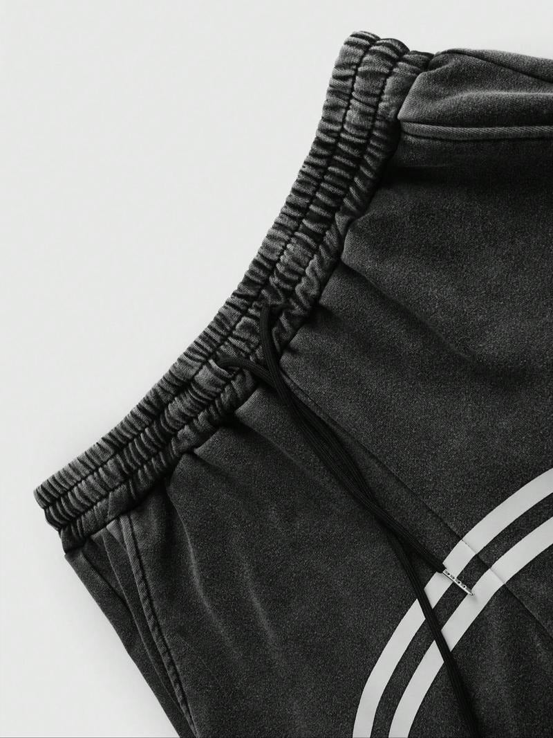 Modern black men's casual track pants, tapered fit & practical zip hems. Ideal for active or relaxed streetwear.
