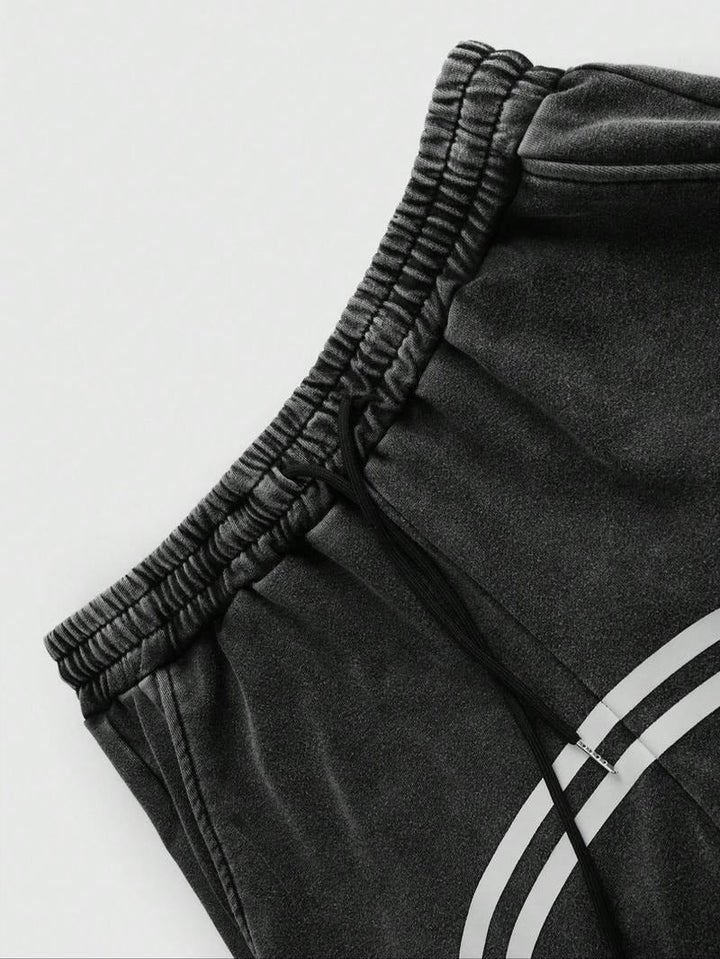 Modern black men's casual track pants, tapered fit & practical zip hems. Ideal for active or relaxed streetwear.