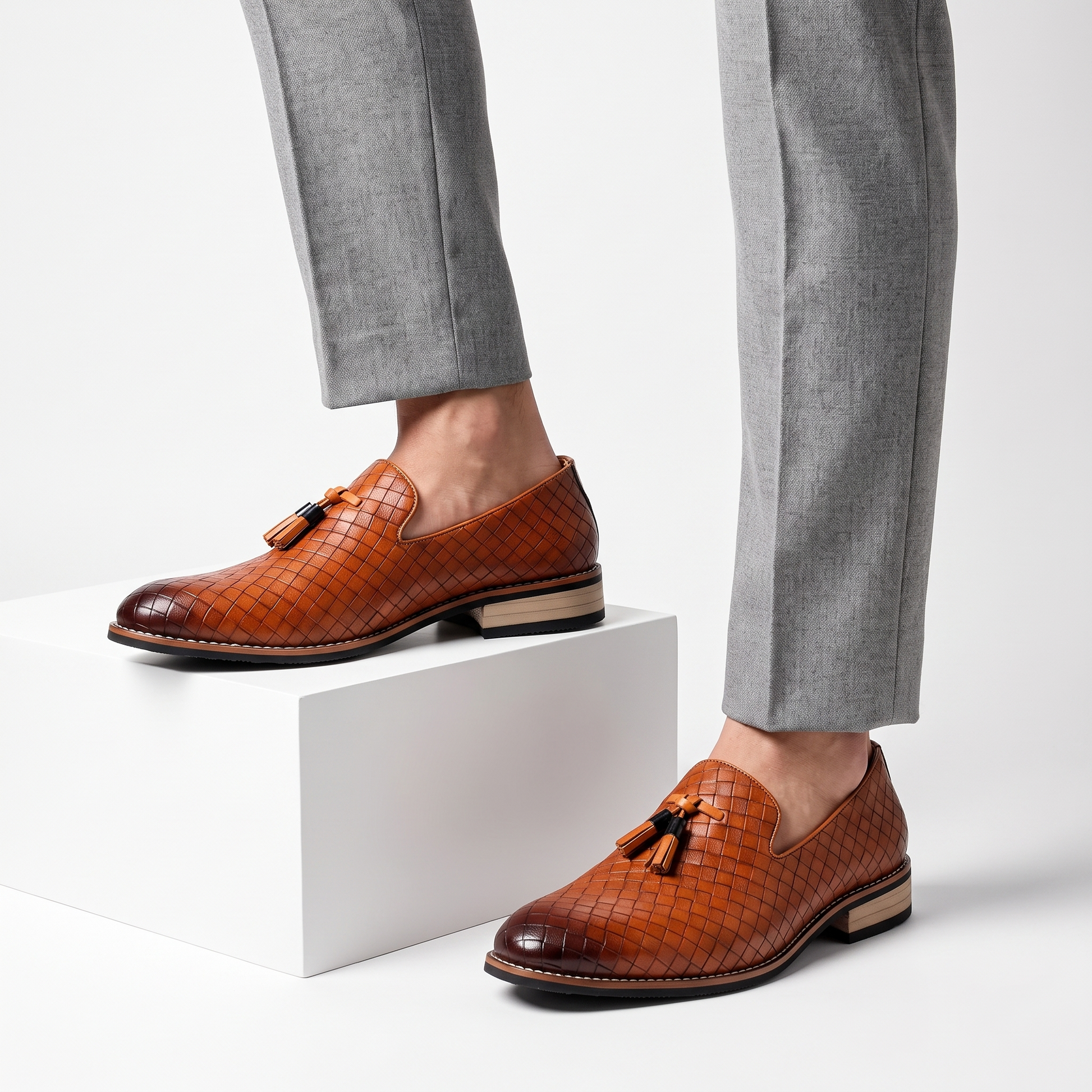 Men's black tassel loafers with a sleek pointed toe, elegant slip-on dress shoes for formal or smart casual occasions.