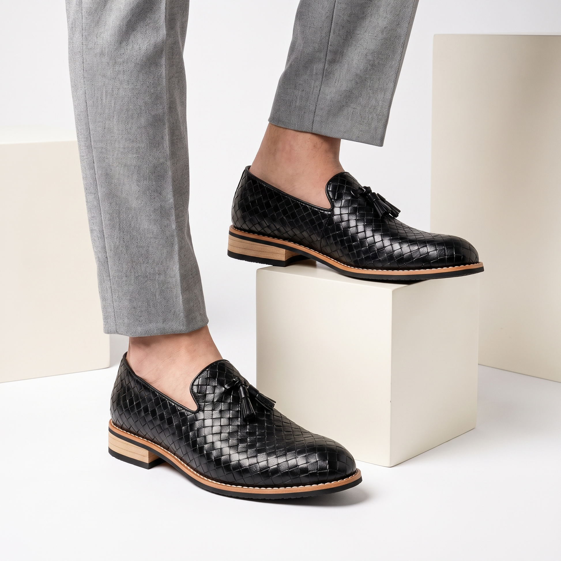 Close-up of men's pointed toe tassel loafers, showcasing the luxurious leather and slip-on design of these dress shoes.