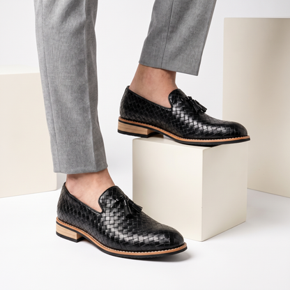 Close-up of men's pointed toe tassel loafers, showcasing the luxurious leather and slip-on design of these dress shoes.