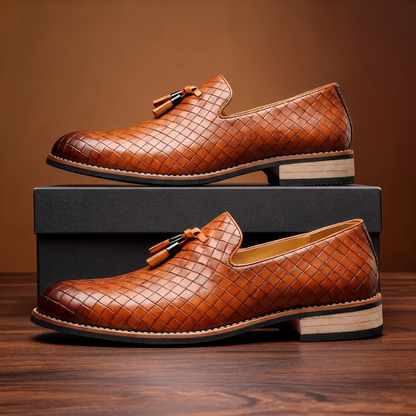 Formal men's slip-on dress shoes, black tassel loafers with a sharp pointed toe, perfect for business or special events.
