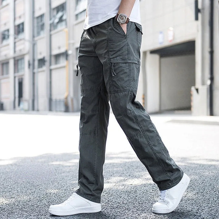 Dark grey men's tech cargo pants, a comfortable fit with multi-pockets for casual and everyday style.