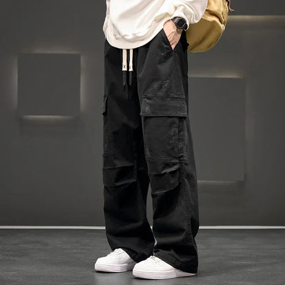 Men's black utility cargo pants with multiple pockets, relaxed fit, & drawstring waist for casual everyday wear.