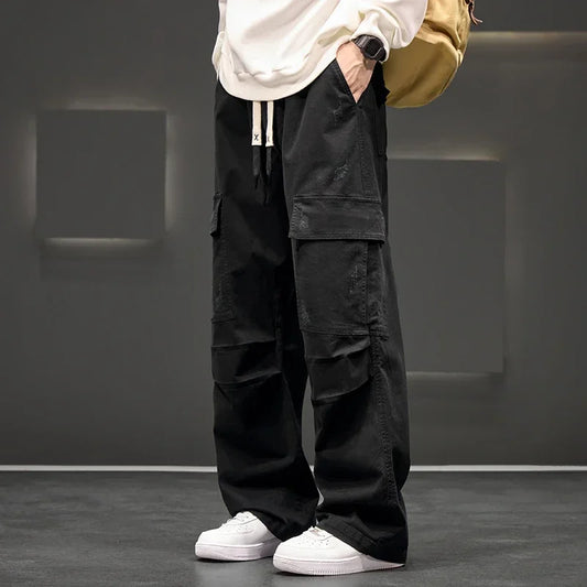 Men's black utility cargo pants with multiple pockets, relaxed fit, & drawstring waist for casual everyday wear.