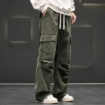 Man wearing relaxed fit utility cargo pants, walking outdoors, showcasing functional design and freedom of movement.