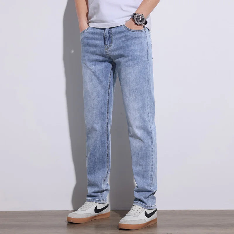 Man posing in comfortable blue stretch core denim jeans, ideal for casual, versatile everyday wear.