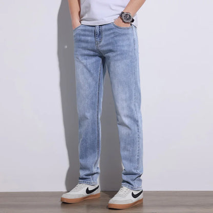 Man posing in comfortable blue stretch core denim jeans, ideal for casual, versatile everyday wear.