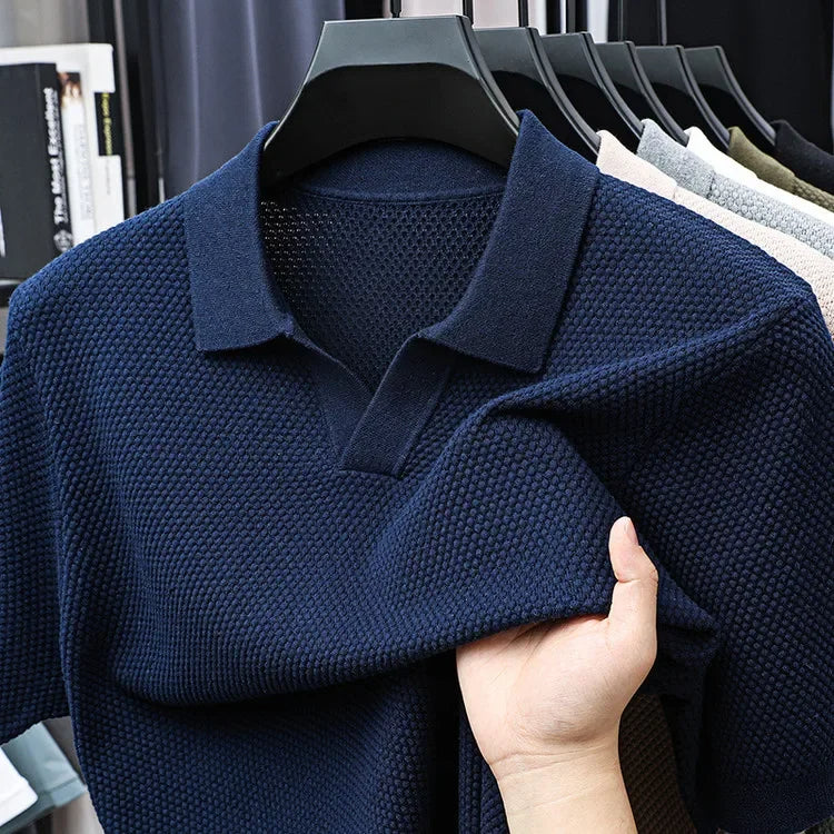 Model showcasing a men's modern fit waffle knit polo shirt in a relaxed setting.