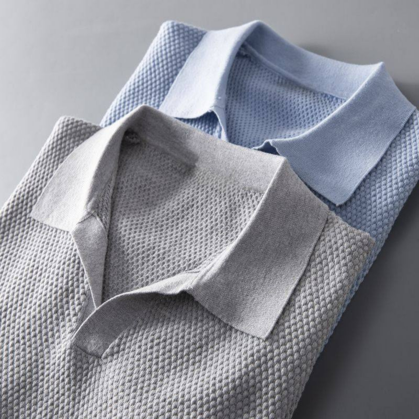 Detail of the collar and waffle knit on a men's modern polo shirt.