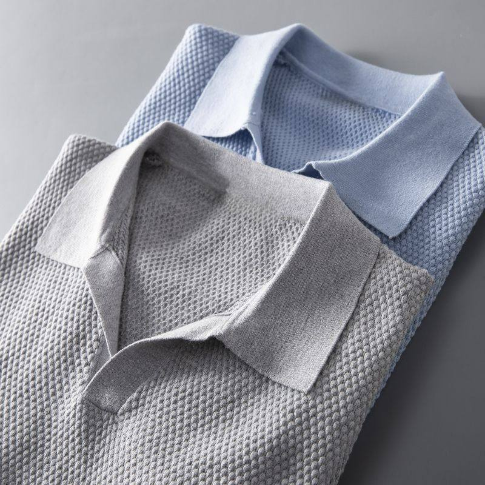 Detail of the collar and waffle knit on a men's modern polo shirt.