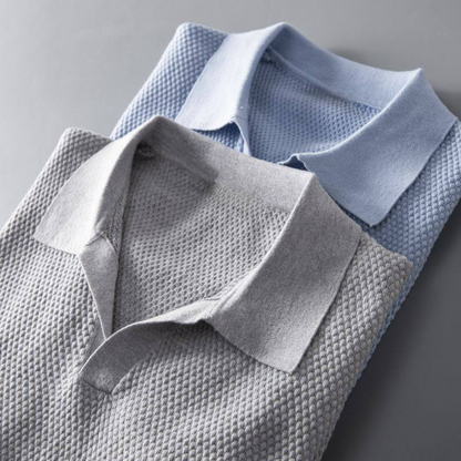 Detail of the collar and waffle knit on a men's modern polo shirt.