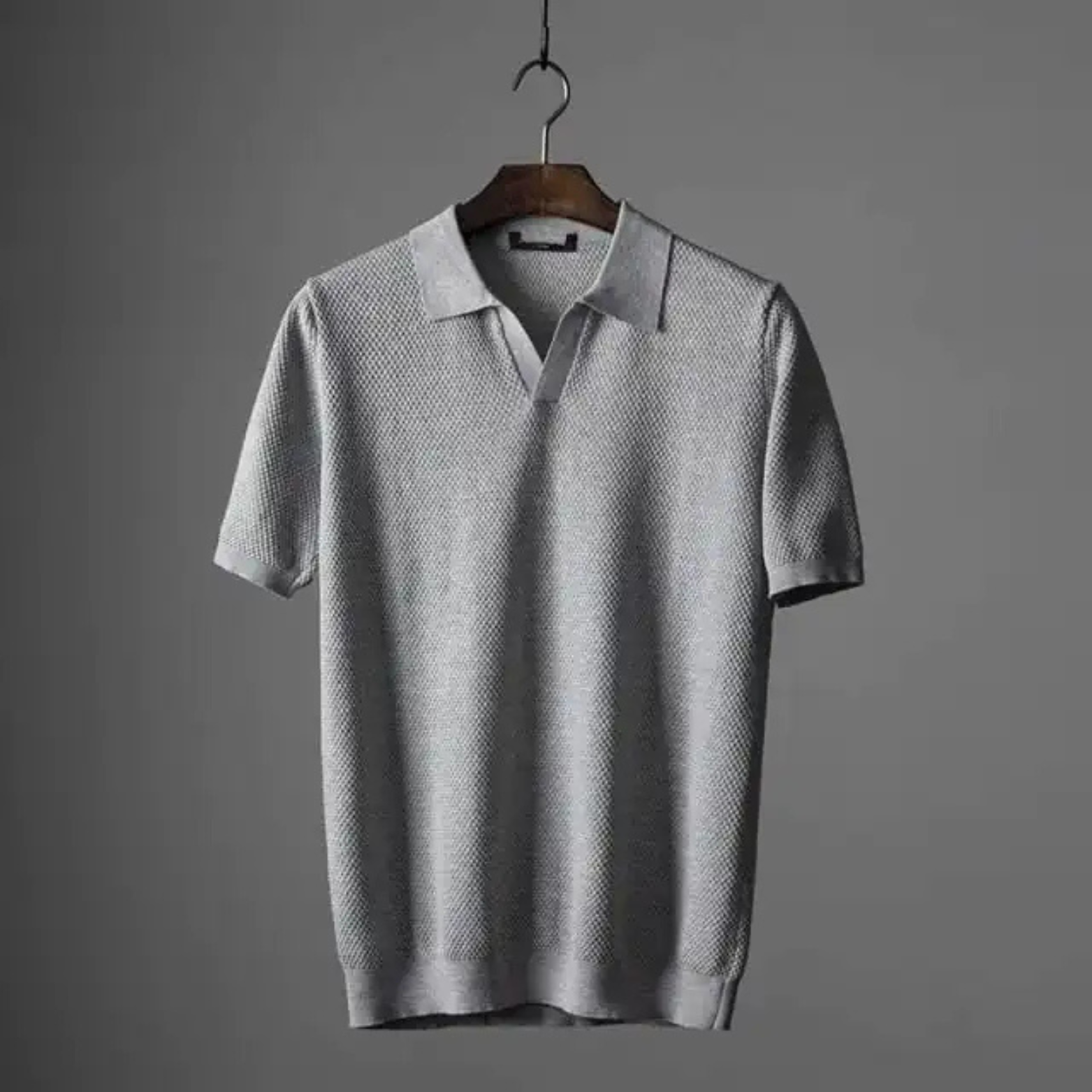 Close-up of the unique waffle knit texture on a men's breathable polo shirt.