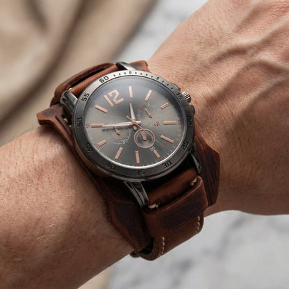 Men's bold vintage statement watch with a wide leather strap. Oversized retro aesthetic.