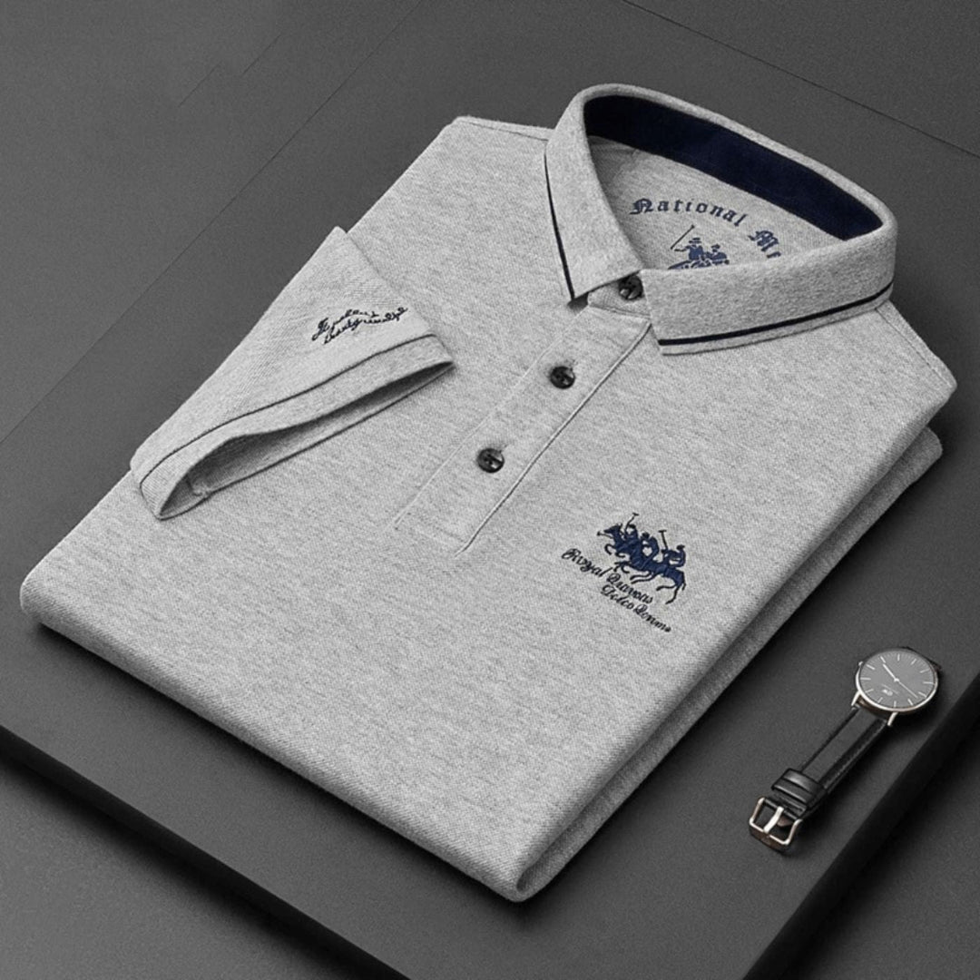 Man in a stylish, breathable embroidered men's polo top in a casual setting, ideal for summer comfort.