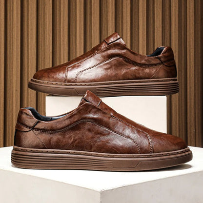 White leather men's casual slip-on shoes, offering comfort and style for everyday wear. Modern mensfootwear.