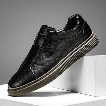 Stylish black leather men's slip-on shoes, designed for casual comfort and everyday use. Quality mensfootwear.