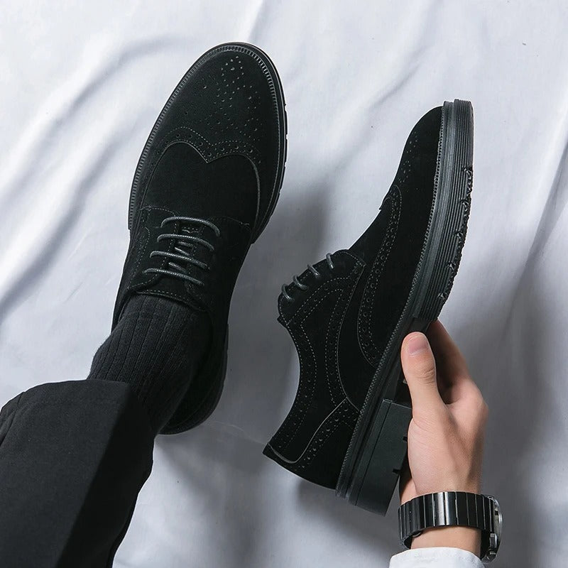 Detailed view of men's brown suede brogue shoes, showcasing the classic perforations and quality craftsmanship.