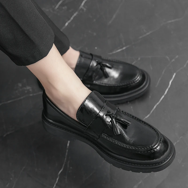Black formal men's tassel loafers, elegant dress shoes for sophisticated everyday wear.