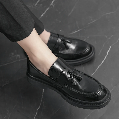 Black formal men's tassel loafers, elegant dress shoes for sophisticated everyday wear.