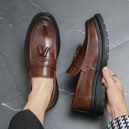 Brown men's tassel slip-on loafers, ideal for stylish everyday formal or casual outfits.