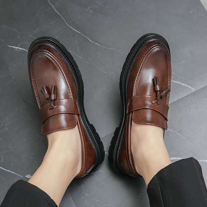 Black men's tassel slip-on loafers, smart dress shoes offering comfort and style.