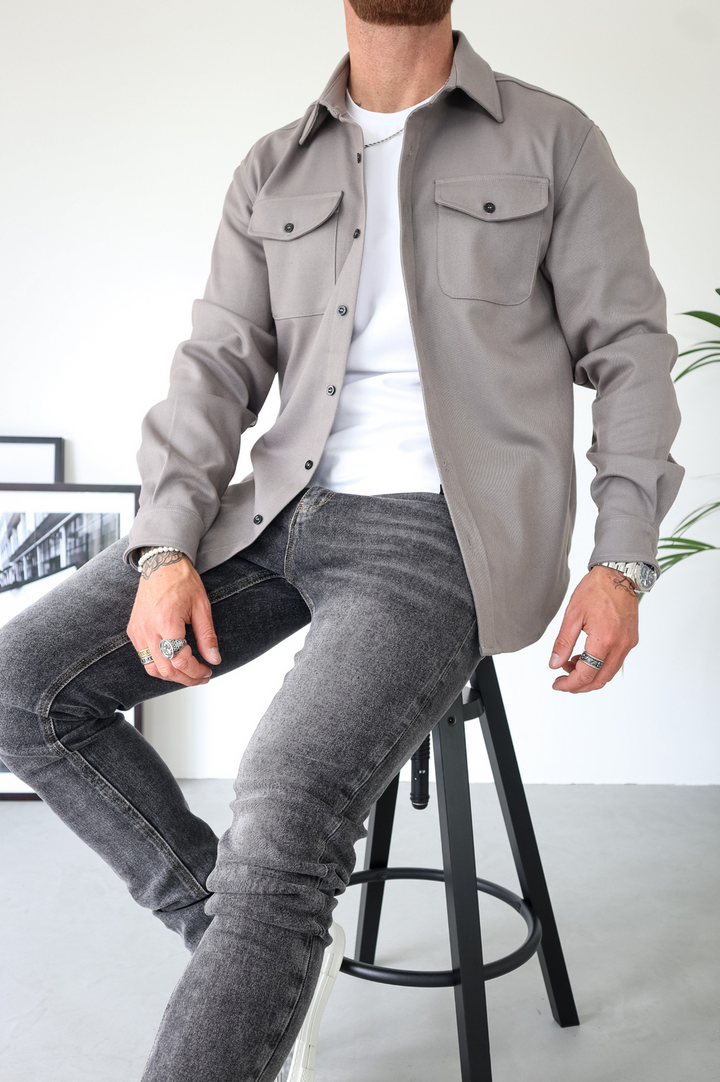Smart casual men's long-sleeve overshirt jacket with button-up front and practical chest pocket design.