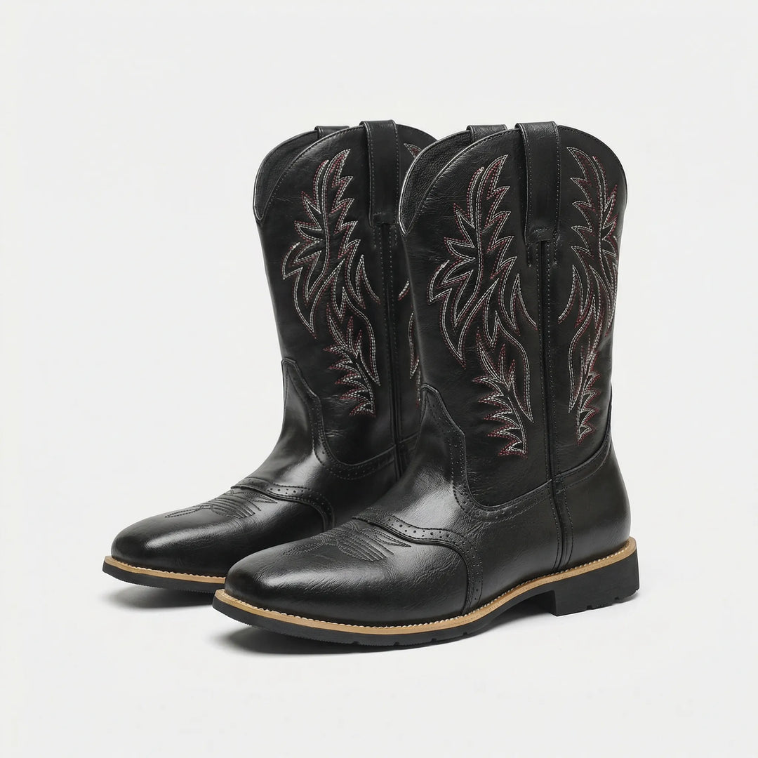 Rugged men's calf-length cowboy boots with bold western embroidery. Durable slip-on style, perfect men's footwear with block heel.