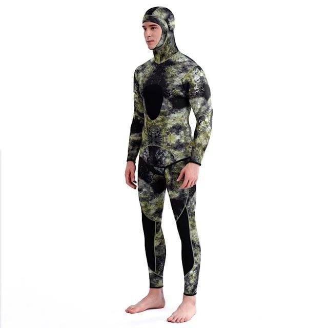Full body shot of a man wearing a camouflage neoprene wetsuit, ready for scuba diving and water sports.